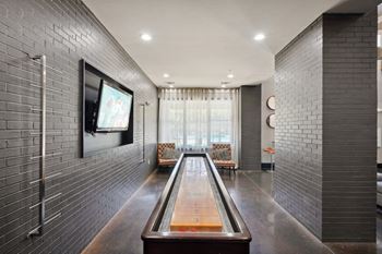 Shuffleboard table in modern game room lounge